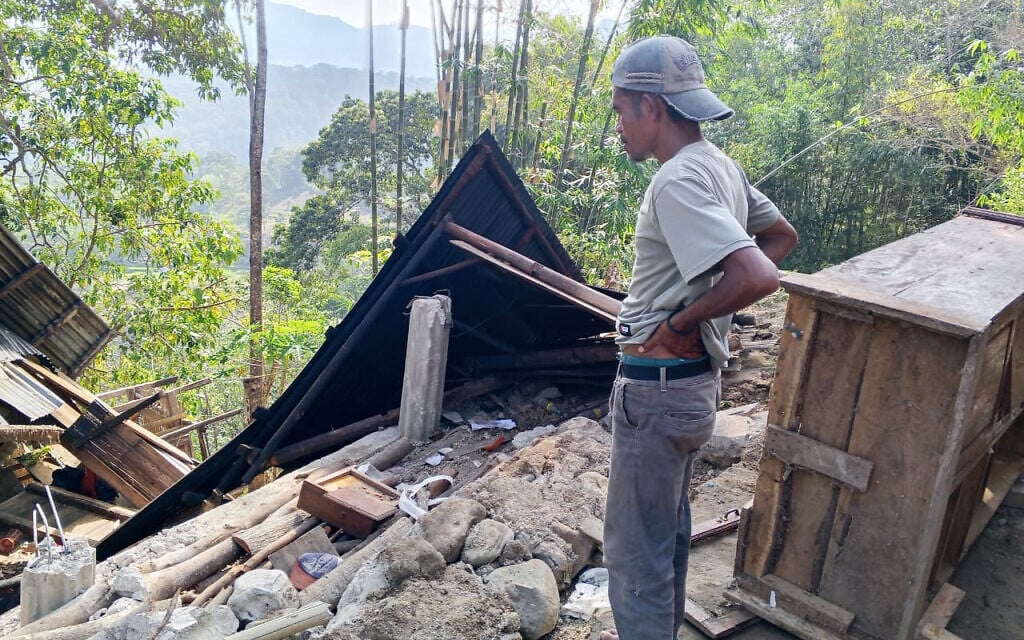 A man examines the damage to a building following an earthquake in East Manggarai, East Nusa Tenggara province, Indonesia, August 15, 2026. (AP Photo/Kurniawan)