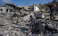 Rescue workers search for victims at a destroyed house that was hit by an Israeli airstrike in Ansar village, southern Lebanon, August 15, 2026. (AP Photo/Mohammed Zaatari)