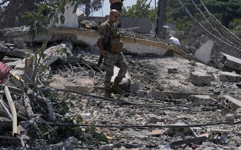 A Lebanese soldier checks the site of a destroyed house that was hit by an Israeli airstrike in Deir al-Zahrani village, southern Lebanon, August 15, 2026. (AP Photo/Mohammed Zaatari)