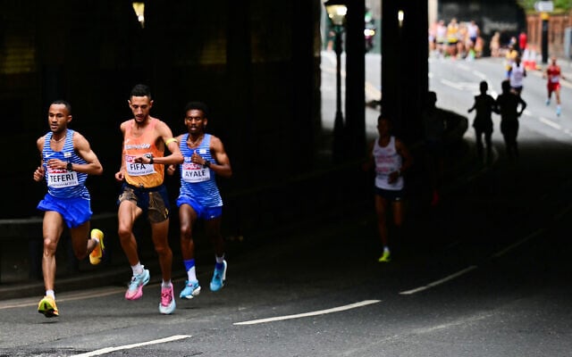 From left, Israel’s Maru Teferi, Spain’s Ilias Fifa and Israel’s Gashau Ayale compete in the men’s marathon during the European Athletics Championships in Birmingham, England, August 16, 2026. (Ben Stansall/Pool via AP)