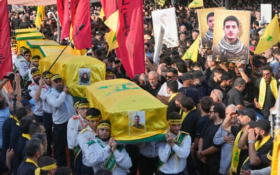 Hezbollah scouts carry the coffins of a Hezbollah member Ali al-Haj Hassan, his wife and his four children, who were killed on Saturday by an Israeli airstrike, during their funeral procession in the southern suburb of Beirut, Lebanon, August 16, 2026. (AP Photo/Hussein Malla) Hezbollah scouts carry the coffins of a Hezbollah member Ali al-Haj Hassan, his wife and his four children, who were killed on Saturday by an Israeli airstrike, during their funeral procession in the southern suburb of Beirut, Lebanon, August 16, 2026. (AP Photo/Hussein Malla)
