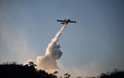 A firefighting airplane drop water during a wildfire on the island of Salamina, west of Athens, Greece, August 16, 2026. (AP Photo/Michael Varaklas) A firefighting airplane drop water during a wildfire on the island of Salamina, west of Athens, Greece, August 16, 2026. (AP Photo/Michael Varaklas)