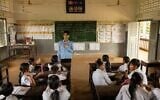 A teacher addresses students at a school in one of the floating villages of Cambodia’s Tonle Sap Lake on June 29, 2026. (AP Photo/Anton L. Delgado)