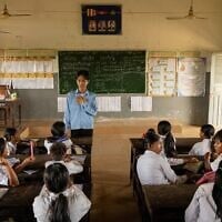 A teacher addresses students at a school in one of the floating villages of Cambodia’s Tonle Sap Lake on June 29, 2026. (AP Photo/Anton L. Delgado)