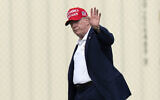 President Donald Trump waves to the media as he walks from Marine One to his limousine upon his arrival at the Ellipse just outside of the White House, August 16, 2026, in Washington. (AP Photo/Jose Luis Magana)