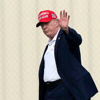 President Donald Trump waves to the media as he walks from Marine One to his limousine upon his arrival at the Ellipse just outside of the White House, August 16, 2026, in Washington. (AP Photo/Jose Luis Magana)