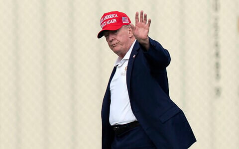 President Donald Trump waves to the media as he walks from Marine One to his limousine upon his arrival at the Ellipse just outside of the White House, August 16, 2026, in Washington. (AP Photo/Jose Luis Magana)