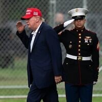 US President Donald Trump returns a salute as he walks from Marine One to his limousine upon his arrival at the Ellipse just outside of the White House, August 16, 2026, in Washington. (AP/Jose Luis Magana)