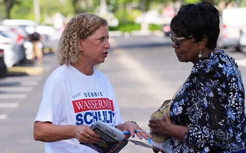 US Representative Debbie Wasserman Schultz, left, greets voters while campaigning for Florida’s 20th congressional district in the Florida primary election, August 18, 2026, in Tamarac, Florida. (AP Photo/Lynne Sladky)