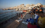 Palestinians inspect the damage after an Israeli airstrike on a cafe at the Gaza port in Gaza City, August 18, 2026. (AP Photo/Jehad Alshrafi)