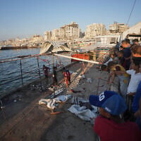 Palestinians inspect the damage after an Israeli airstrike on a cafe at the Gaza port in Gaza City, August 18, 2026. (AP Photo/Jehad Alshrafi)