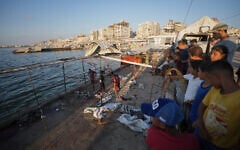Palestinians inspect the damage after an Israeli airstrike on a cafe at the Gaza port in Gaza City, August 18, 2026. (AP Photo/Jehad Alshrafi)
