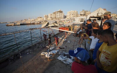 Palestinians inspect the damage after an Israeli airstrike on a cafe at the Gaza port in Gaza City, August 18, 2026. (AP Photo/Jehad Alshrafi)