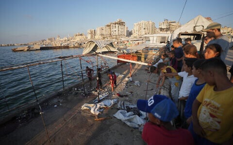 Palestinians inspect the damage after an Israeli airstrike on a cafe at the Gaza port in Gaza City, August 18, 2026. (AP Photo/Jehad Alshrafi)