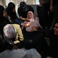 Mourners attend the funeral of Palestinians who were killed in an Israeli army strike on a cafe at the Gaza port the previous day, at Shifa Hospital in Gaza City, August 19, 2026. (AP/Jehad Alshrafi)
