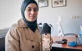 Wesam Hamada, the mother of Hind Rajab, a Palestinian girl who was killed in Gaza City in January 2024 after the car she was in with relatives came under Israeli fire, shows a picture of her late daughter during an interview with The Associated Press at an undisclosed location, August 21, 2026.