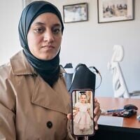 Wesam Hamada, the mother of Hind Rajab, a Palestinian girl who was killed in Gaza City in January 2024 after the car she was in with relatives came under Israeli fire, shows a picture of her late daughter during an interview with The Associated Press at an undisclosed location, August 21, 2026.