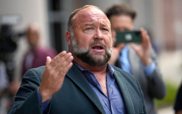 Right-wing conspiracy theorist Alex Jones speaks to the media after arriving at the federal courthouse for a hearing in front of a bankruptcy judge in Houston, June 14, 2024. (AP Photo/David J. Phillip)