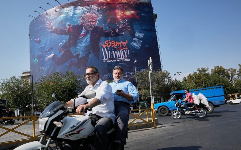 Motorcyclists pass a billboard depicting US President Donald Trump underwater amid explosions, with the words “Great Victory! Strait of Hormuz,” in Tehran, Iran, August 24, 2026. (AP/Vahid Salemi) Motorcyclists pass a billboard depicting US President Donald Trump underwater amid explosions, with the words “Great Victory! Strait of Hormuz,” in Tehran, Iran, August 24, 2026. (AP/Vahid Salemi)