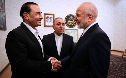 In this photo released by Islamic Consultative Assembly News Agency, ICANA, Iran’s Parliament Speaker and top negotiator Mohammad Bagher Ghalibaf, right, shakes hands with Pakistan’s Army Chief Field Marshal Gen. Asim Munir during their meeting in Tehran, Iran, August 24, 2026. (Mahmoud Hosseini/ICANA via AP)