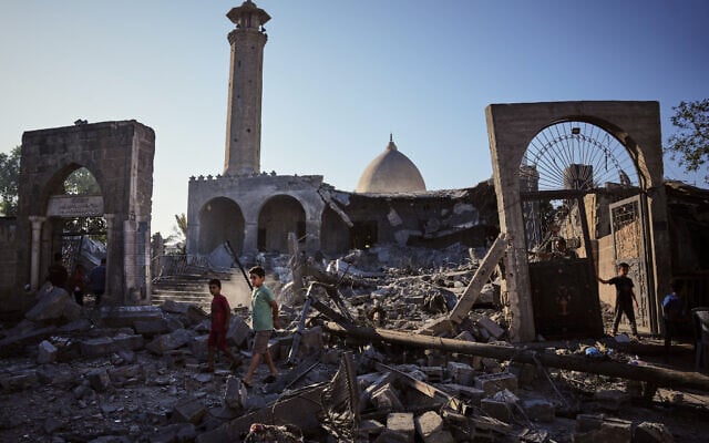 Palestinians inspect the Abu Salim Mosque a day after it was hit by an Israeli airstrike, in Deir al-Balah, central Gaza Strip, August 25, 2026. (AP Photo/Abdel Kareem Hana)