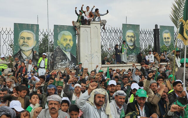 Houthi supporters shout slogans in front of posters showing from right to left; late Iranian military officer, Qasem Soleimani, deputy commander of the Popular Mobilization Forces, Abu Mahdi al-Muhandis, late Hamas leader Yahya Sinwar and Ismail Haniyeh, during a rally to mark Prophet Muhammad’s birthday, known as Moulid, in Sanaa, Yemen, August 25, 2026. (AP Photo/Osamah Abdulrahman)