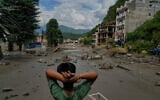 A boy looks at the devastation caused by flash flooding along the Trishuli River in Nepal’s Nuwakot district, August 26, 2026. (AP Photo/Niranjan Shrestha)