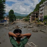 A boy looks at the devastation caused by flash flooding along the Trishuli River in Nepal’s Nuwakot district, August 26, 2026. (AP Photo/Niranjan Shrestha)