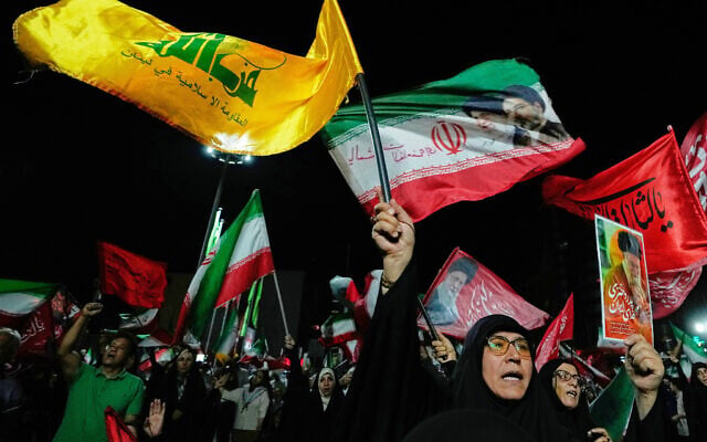 A pro-Iranian regime demonstrator waves a flag of Lebanon’s Hezbollah terror group during a rally in Tehran, Iran, August 26, 2026. (AP Photo/Vahid Salemi)