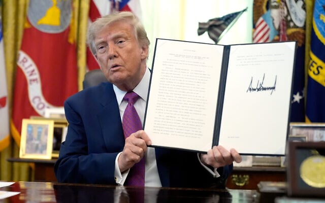 President Donald Trump holds up a signed executive order in the Oval Office of the White House, August 27, 2026, in Washington. (AP/Manuel Balce Ceneta) President Donald Trump holds up a signed executive order in the Oval Office of the White House, August 27, 2026, in Washington. (AP/Manuel Balce Ceneta)