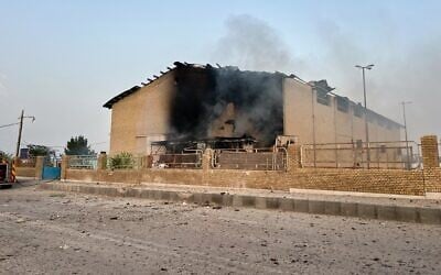 Smoke rises from a building damaged in a strike in Lamerd, southern Iran, February 28, 2026. (Alireza Ameri/Tasnim News Agency via AP)