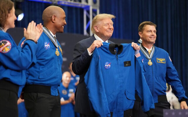 US President Donald Trump holds up a flight jacket presented to him by Artemis II crew members Christina Koch, from left, Victor Glover, Reid Wiseman and Jeremy Hansen, obstructed, after the crew accepted the Congressional Space Medal of Honor, August 28, 2026, at Johnson Space Center in Houston. (AP Photo/Mark Schiefelbein) US President Donald Trump holds up a flight jacket presented to him by Artemis II crew members Christina Koch, from left, Victor Glover, Reid Wiseman and Jeremy Hansen, obstructed, after the crew accepted the Congressional Space Medal of Honor, August 28, 2026, at Johnson Space Center in Houston. (AP Photo/Mark Schiefelbein)