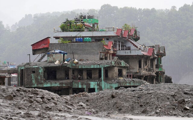 A damaged house stands amidst debris of flash flooding in Nuwakot district in Nepal, August 29, 2026. (AP Photo/Rajesh Kumar Singh)
