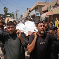 Palestinian mourners carry the body of a man killed by the Israeli army, during his funeral at al-Aqsa Hospital in Deir al-Balah, central Gaza Strip, August 29, 2026. (AP Photo/Abdel Kareem Hana)