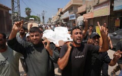 Palestinian mourners carry the body of a man killed by the Israeli army, during his funeral at al-Aqsa Hospital in Deir al-Balah, central Gaza Strip, August 29, 2026. (AP Photo/Abdel Kareem Hana)