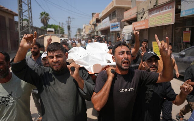 Palestinian mourners carry the body of Hamouda al-Attar, who was killed by the Israeli army, during his funeral at al-Aqsa Hospital in Deir al-Balah, central Gaza Strip, August 29, 2026. (AP Photo/Abdel Kareem Hana)