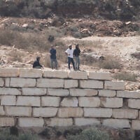 Settlers enter Palestinian properties in the West Bank village of Qusra, August 29, 2026. (AP Photo/Majdi Mohammed)