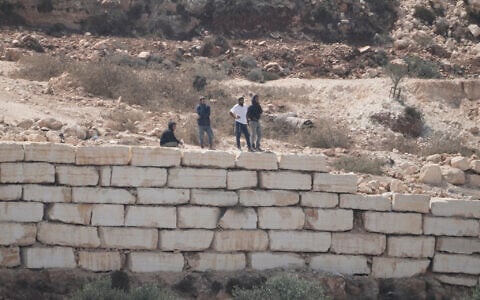 Settlers enter Palestinian properties in the West Bank village of Qusra, August 29, 2026. (AP Photo/Majdi Mohammed)