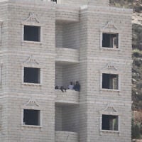 Israeli settlers are seen inside a Palestinian building under construction in the West Bank village of Qusra, August 29, 2026. (AP Photo/Majdi Mohammed) Israeli settlers are seen inside a Palestinian building under construction in the West Bank village of Qusra, August 29, 2026. (AP Photo/Majdi Mohammed)