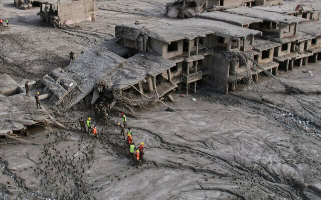 A drone view shows rescue workers inspect the area and damaged structures following recent flash flooding along the Trishuli River in the Devighat area of Nuwakot district, Nepal, August 29, 2026. (AP Photo/Rajesh Kumar Singh)