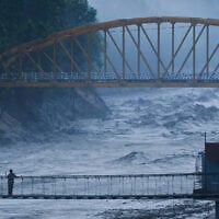 A resident looks at the swollen Trishuli river in Galchhi, Dhading District, Nepal, August 30, 2026. (AP Photo/Niranjan Shrestha)