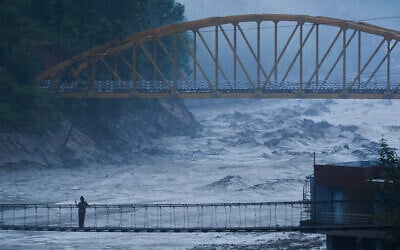 A resident looks at the swollen Trishuli river in Galchhi, Dhading District, Nepal, August 30, 2026. (AP Photo/Niranjan Shrestha)