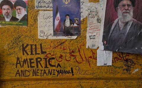Mementoes and messages are written alongside photos of the Iranian Supreme Leader Ayatollah Mojtaba Khamenei, left, and his father, the late Supreme Leader Ayatollah Ali Khamenei on a barricade placed on the street leading to their residence compound where the late Ayatollah Ali Khamenei was killed during the US and Israel strike on February 28, in Tehran, Iran, August 31, 2026. (AP Photo/Vahid Salemi)