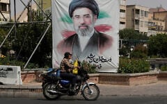 A man drives past a banner showing a portrait of the Iranian Supreme Leader Ayatollah Mojtaba Khamenei, in downtown Tehran, Iran, August 31, 2026. (AP Photo/Vahid Salemi)