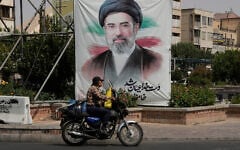 A man drives past a banner showing a portrait of Iranian Supreme Leader Ayatollah Mojtaba Khamenei, in downtown Tehran, Iran, August 31, 2026. (AP Photo/Vahid Salemi)