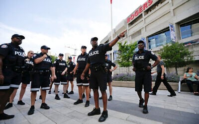 Toronto police meet in front of the Rogers Centre before the opening ceremony for the Pan Am Games in Toronto, July 10, 2015. (AP/Gregory Bull) Toronto police meet in front of the Rogers Centre before the opening ceremony for the Pan Am Games in Toronto, July 10, 2015. (AP/Gregory Bull)