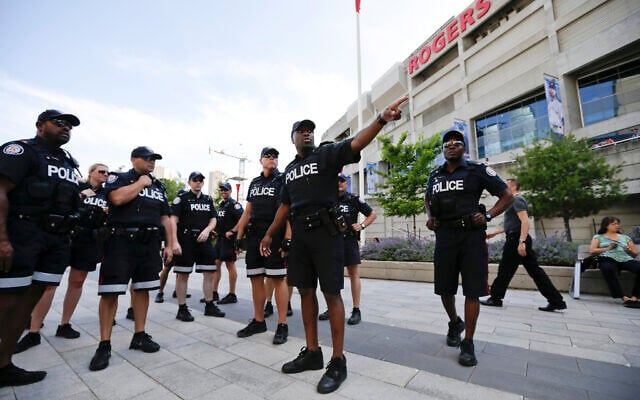 Toronto police meet in front of the Rogers Centre before the opening ceremony for the Pan Am Games in Toronto, July 10, 2015. (AP/Gregory Bull)