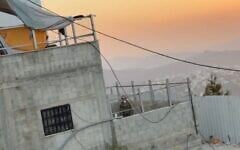 A screenshot of video in which Israeli troops toss clothes belonging to Palestinians from the window of a home in the West Bank village of Qusra, August 20, 2026. (X screenshot)