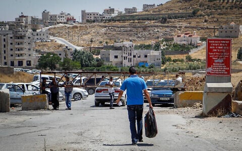Illustrative: A checkpoint at the entrance of the West Bank village of Sa'ir, on July 11, 2016. A sign warns Israelis they are prohibited from entering. (Wisam Hashlamoun/Flash90)