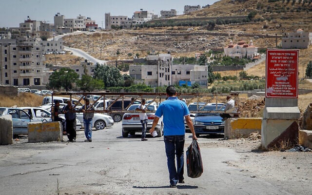 Illustrative: A checkpoint at the entrance of the West Bank village of Sa'ir, on July 11, 2016. A sign warns Israelis they are prohibited from entering. (Wisam Hashlamoun/Flash90)